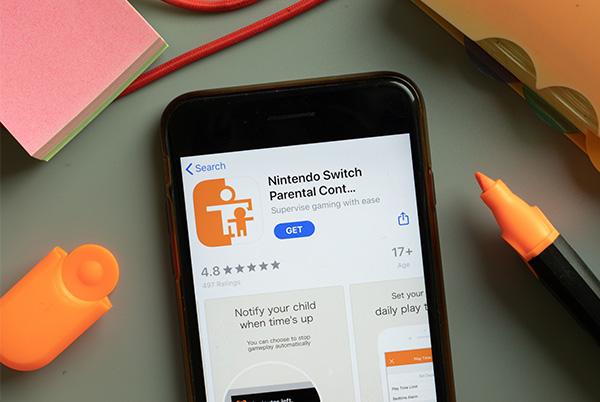 a smartphone with the nintendo switch parental controls app on its screen