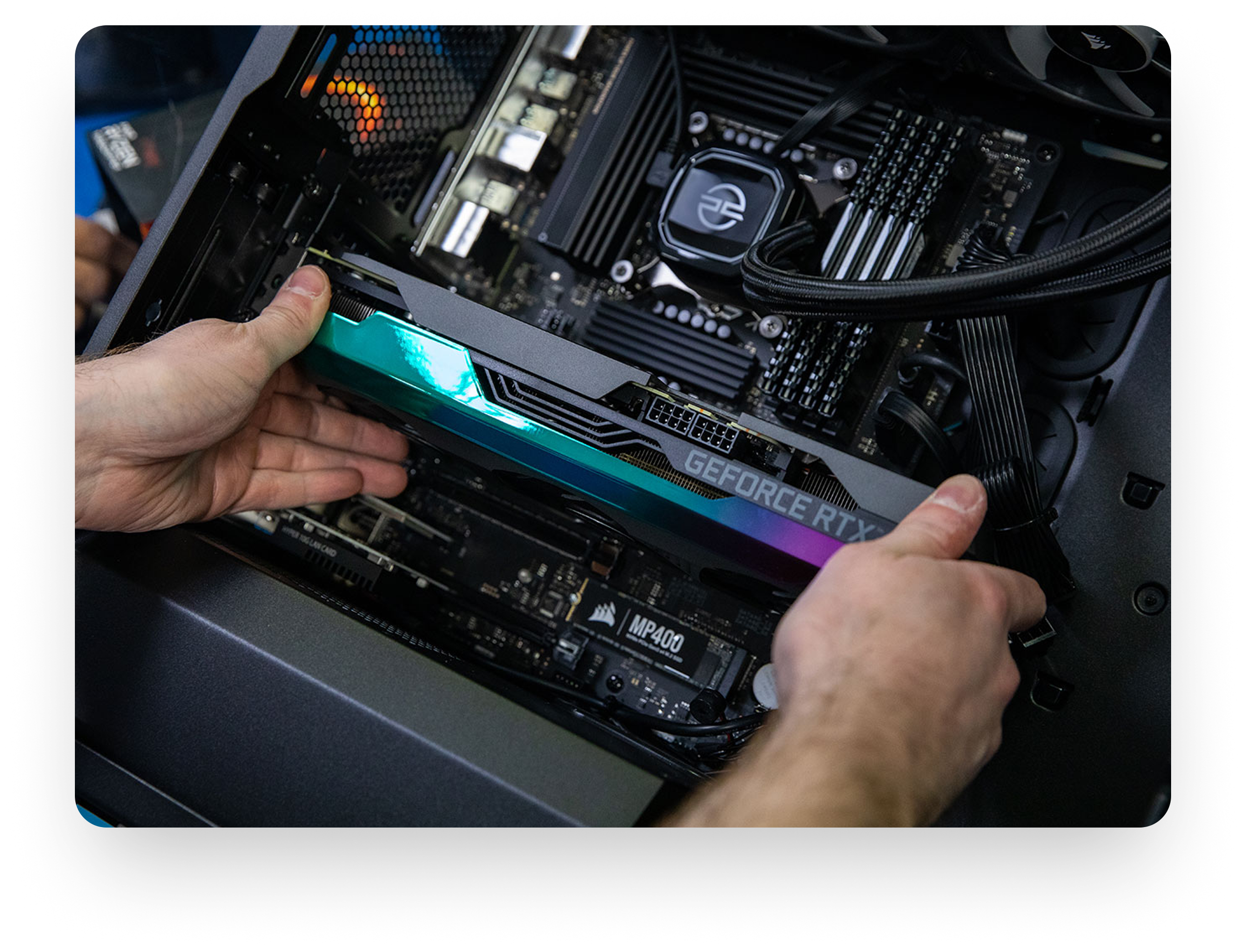 a person putting a PC component into an open PC