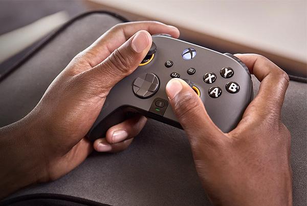 a person holding a scuf instinct pro wireless controller in their hands