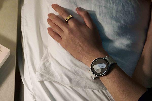 a person laying in bed with a samsung galaxy watch 7 on their wrist
