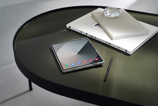 samsung galaxy z fold6 phone on a coffee table with notebook