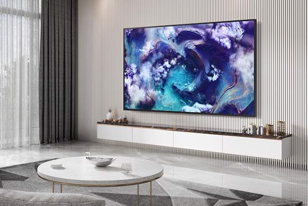 a living room with a large samsung qn900f 8k tv on the wall