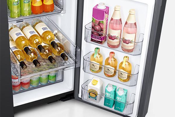 a refrigerator with a door open showing a variety of drinks