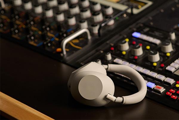 a pair of sony wh-1000xm6 headphone on a mixing desk in a studio