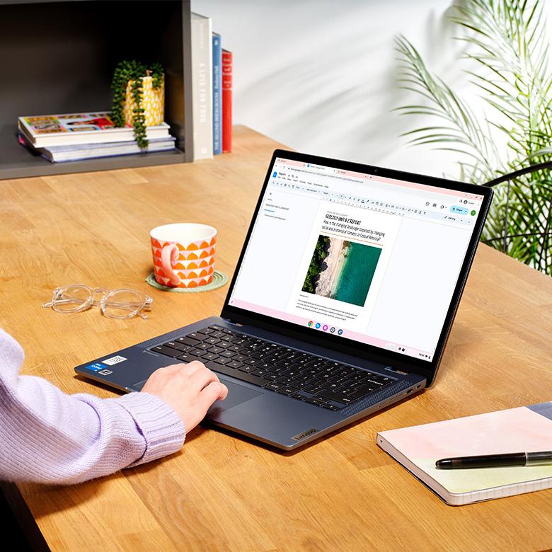 person using lenovo ideapad flex 5 laptop touchpad on desk