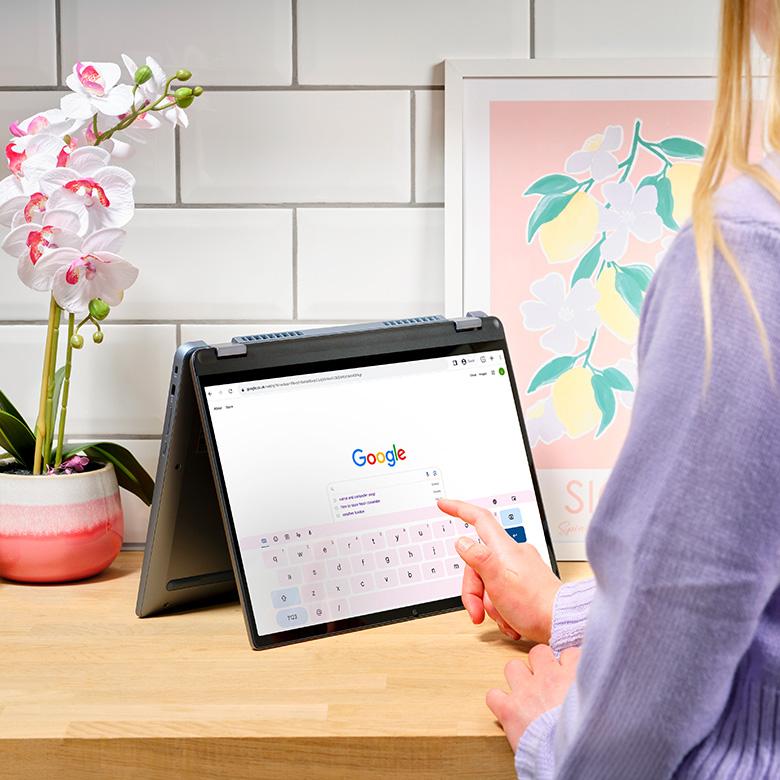lenovo ideapad flex 5 laptop on table in tabletop mode being used by person