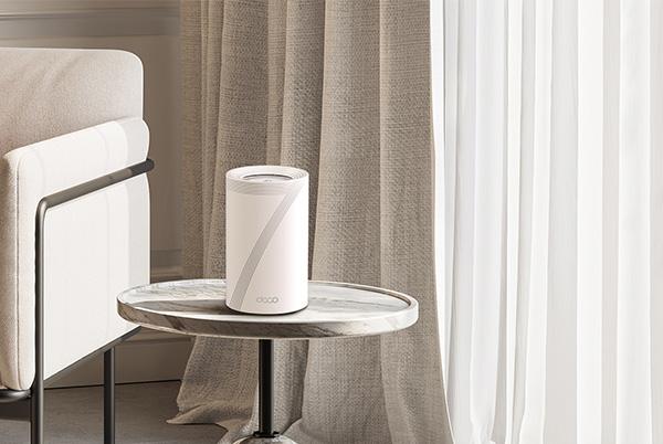 a small table with a tp link deco on it next to a chair