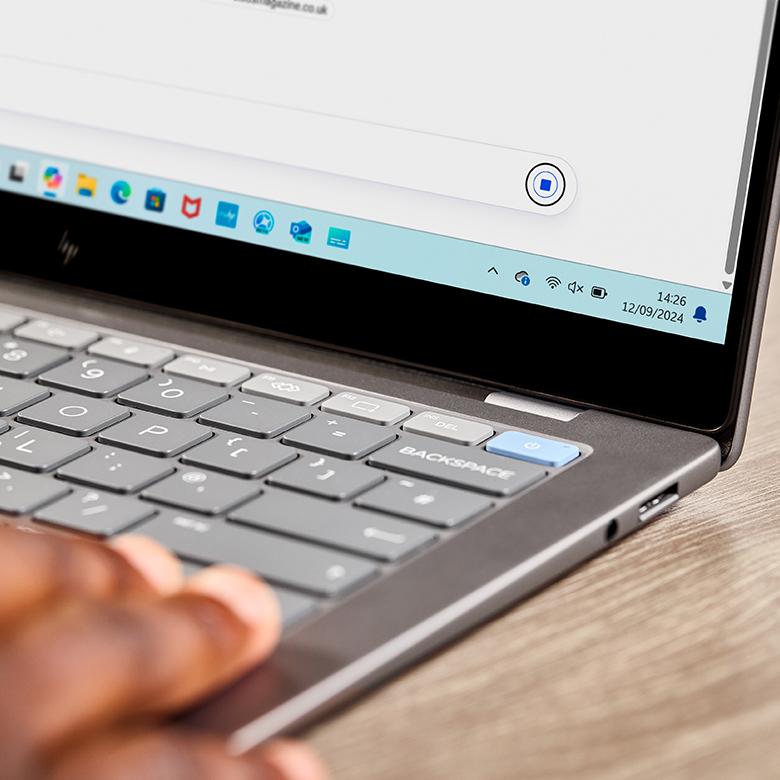 a person typing on a laptop computer keyboard with their fingers