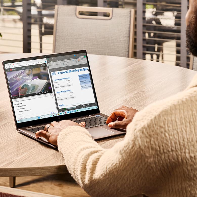a man sitting at a table with a laptop on it