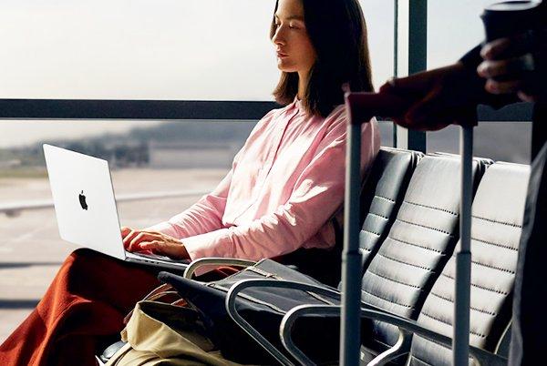 a woman with a MacBook Pro