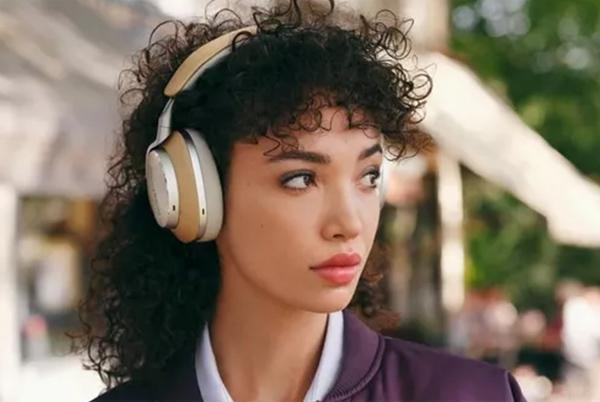 a woman with headphones on and a curly hair