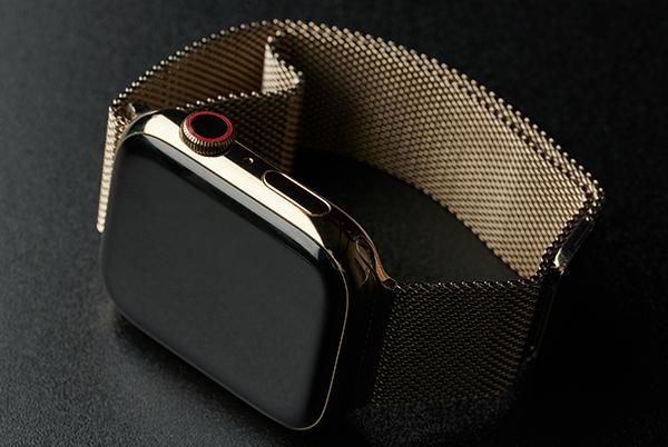 a close up of an apple watch on a black surface