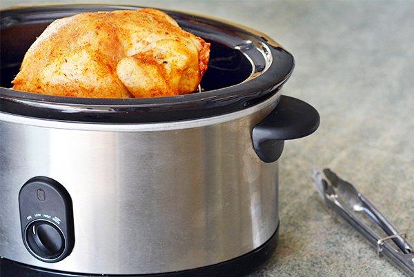 a slow cooker with a chicken in it 