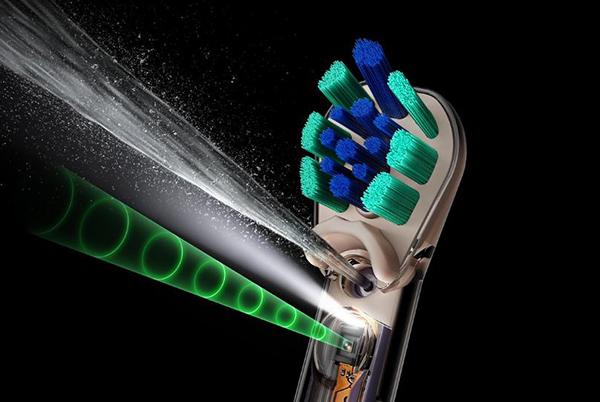a close up of a toothbrush with blue and green lights