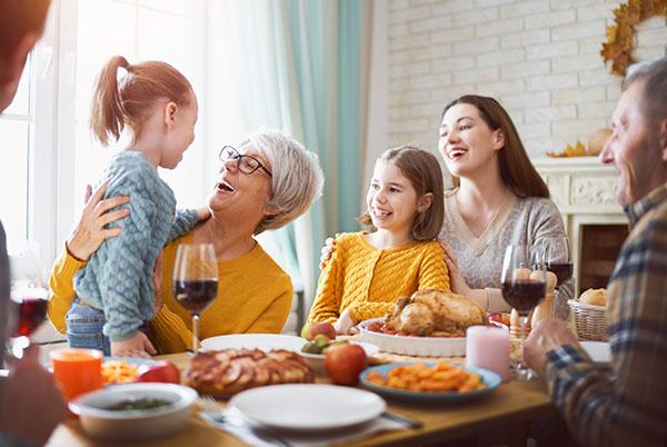 a family is gathered around a table for a meal