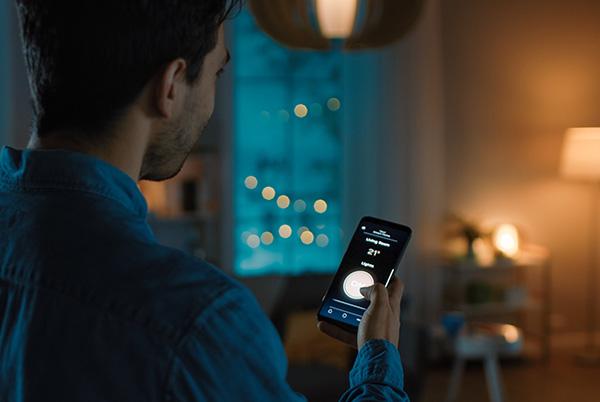 a man controlling smart lighting in his living room