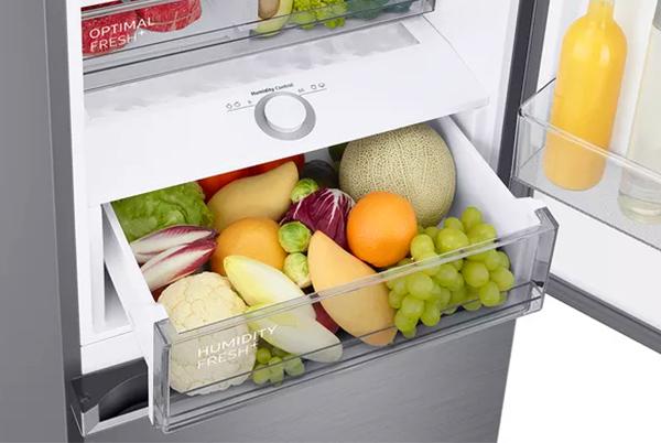 a samsung refrigerator with a door open showing a variety of fruits and vegetables