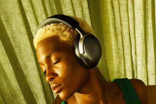 a woman with headphones on and a green shirt