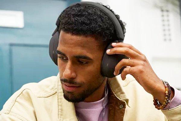 a man with headphones on listening to music on his phone