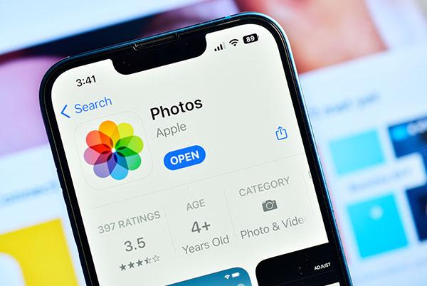 A close up of an iPhone displaying the Photos app on the screen