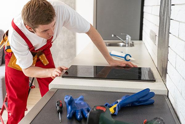 a man repairing an induction hob