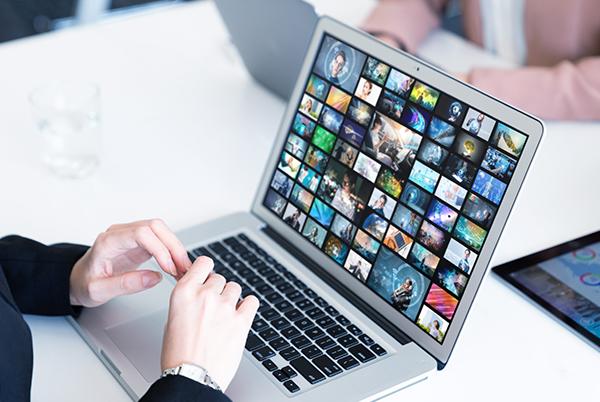 a woman sitting at a table with a laptop on it
