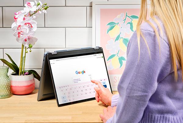 a person is using a laptop with google on it