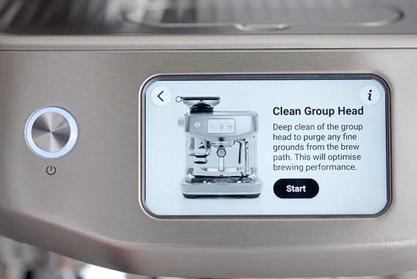 a close up of a coffee machine with a screen saying 'clean grouphead.
