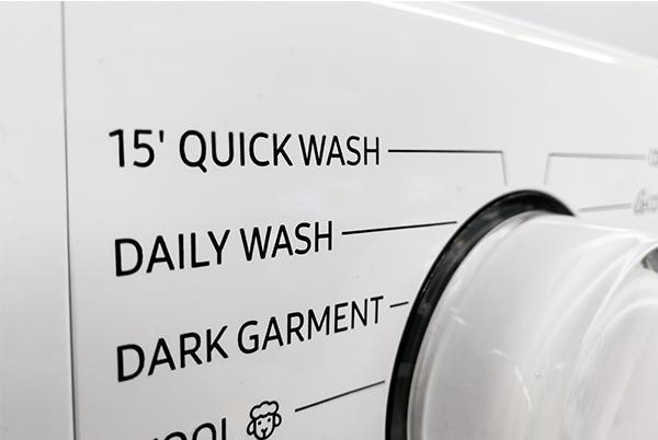 a close up of a washing machine with the quick wash buttons labeled