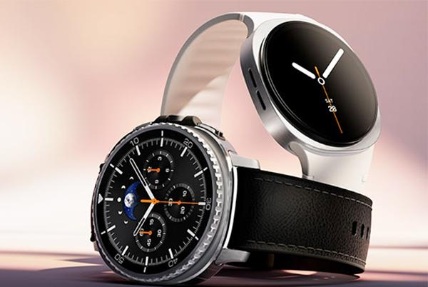 two smart watches are shown on a table with a white background