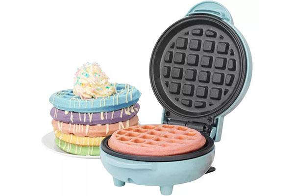 a mini waffle maker with a stack of waffles on top of it