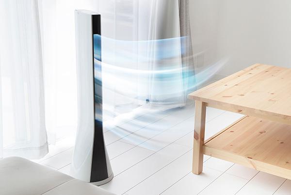 a white room with a table and a tower fan in it blowing cold air