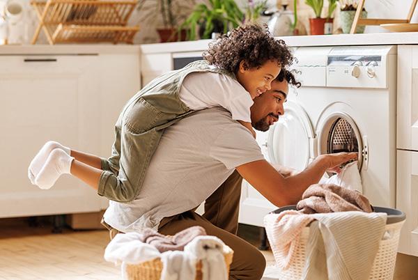 a man and a little girl are in a laundry room