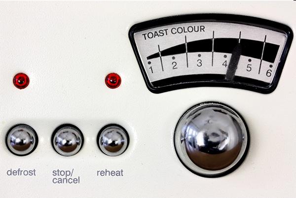 a close up of a toaster controls and buttons