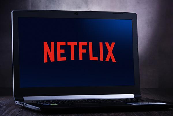 a laptop computer with the netflix logo on it