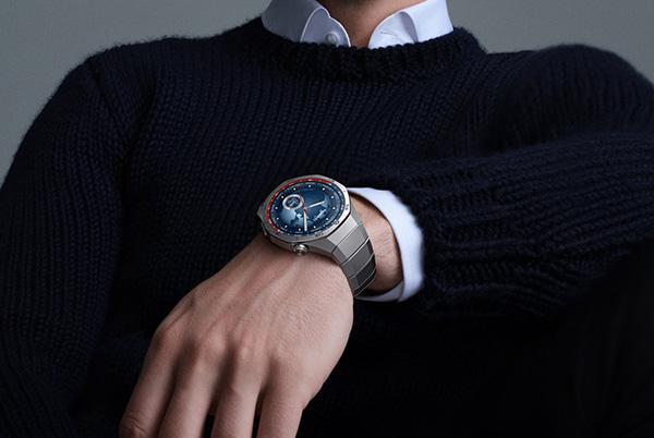a man in a black sweater wearing a huawei watch gt 5 pro smartwatch