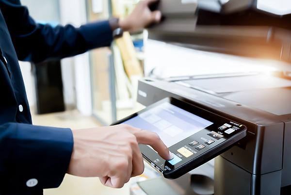 a man is using a screen on a large printer
