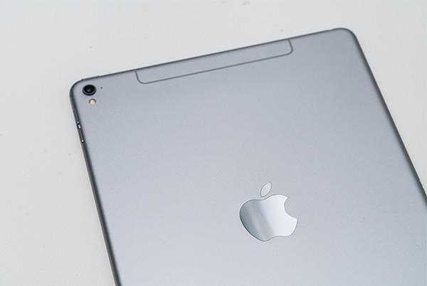 a close up of a silver ipad sitting on a table