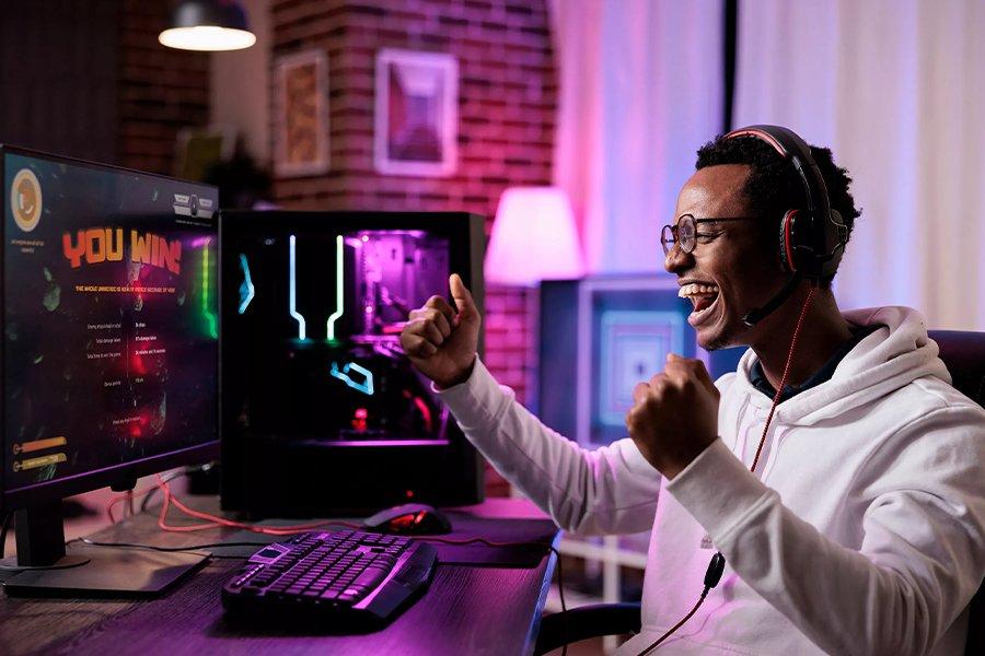 A Men sitting at a PC with a headset on