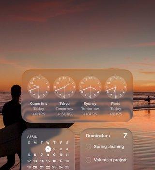 Liquid Glass Clock, Calendar, Reminders and Weather widgets on macOS Tahoe screen over a scene of a surfer walking on the beach at sunset