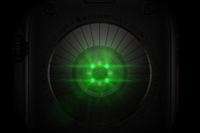 Back of Apple Watch Ultra 4, titanium case, black colour, multiple round sensors with glowing green LED lights