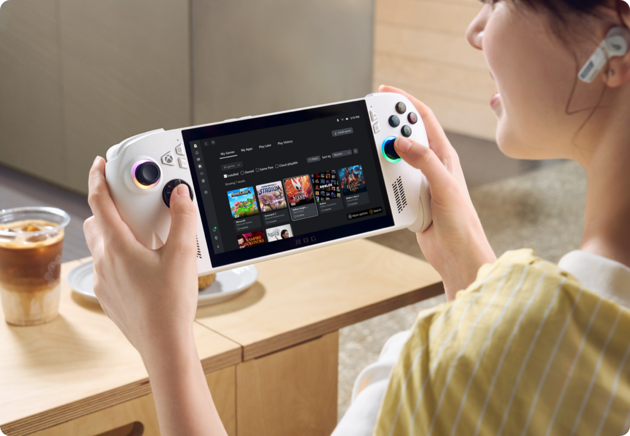 a woman holding a handheld game console in her hand