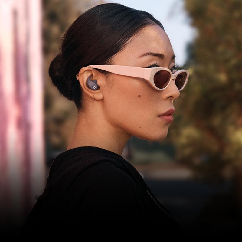 beats fit pro earphones worn by a model