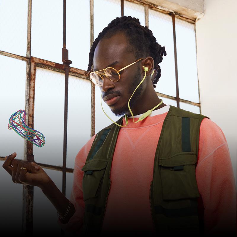 a model wearing beats flex headphones