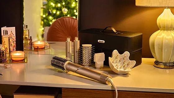 a table with a hair styler and other items on it