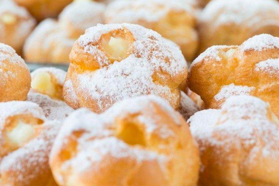 Choux pastry buns covered in icing sugar
