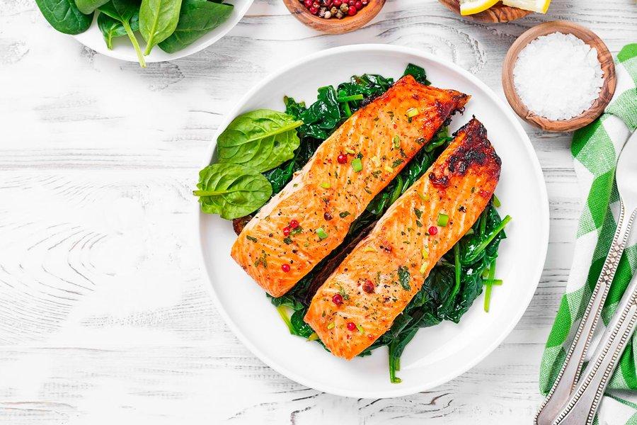 Two salmon flllets on a bed of lettuce on a plate