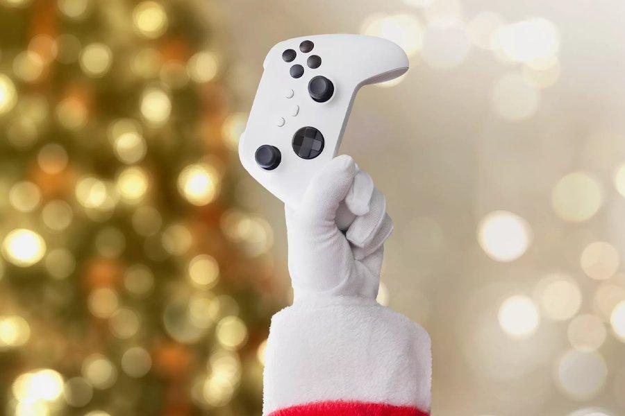 A hand wearing a white glove raising an Xbox controller