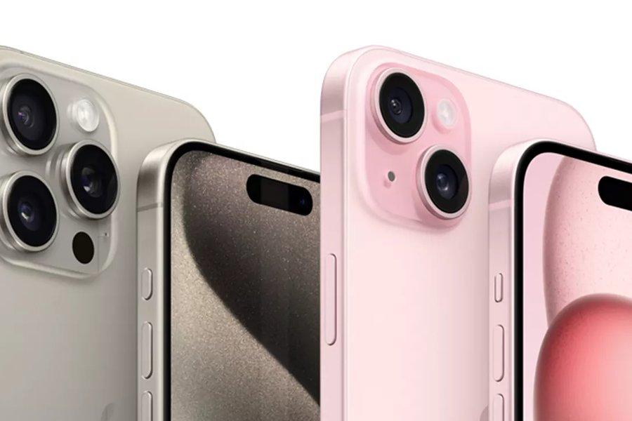 Two silver iphones and two pink iphones standing in a row