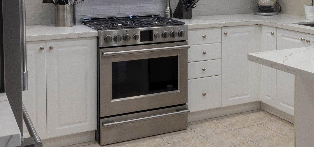 a kitchen with a cooker and a sink and a counter